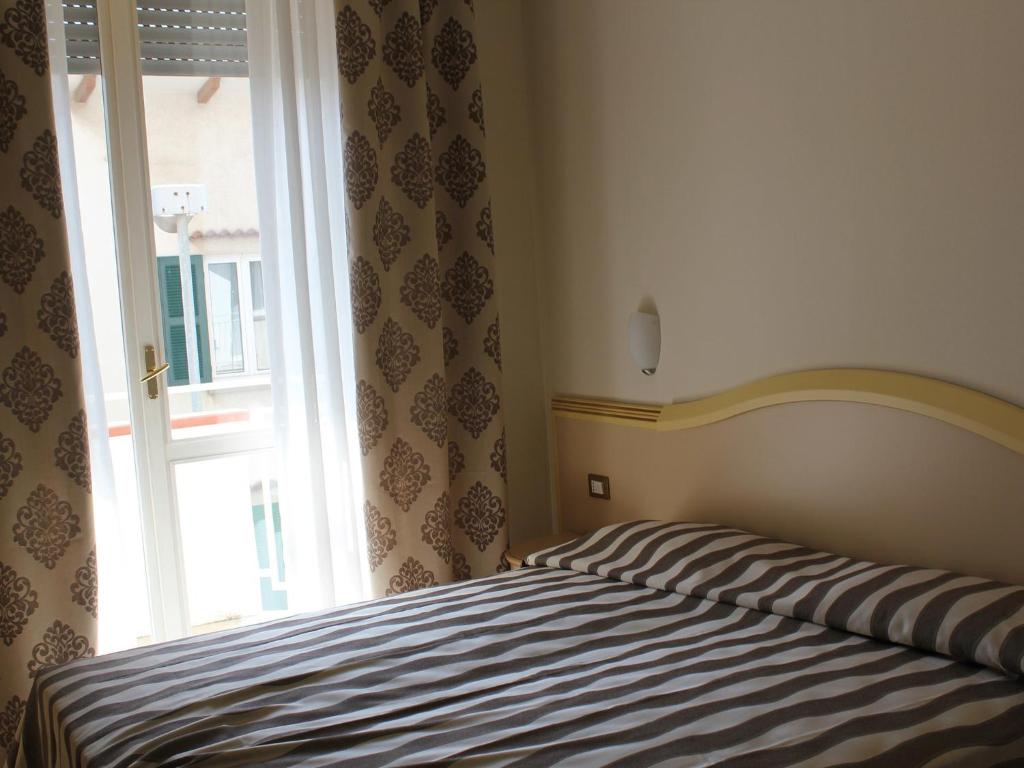Postel nebo postele na pokoji v ubytování Hotel Marina