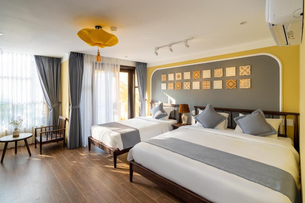 Giường trong phòng chung tại Hoianan Boutique Hotel