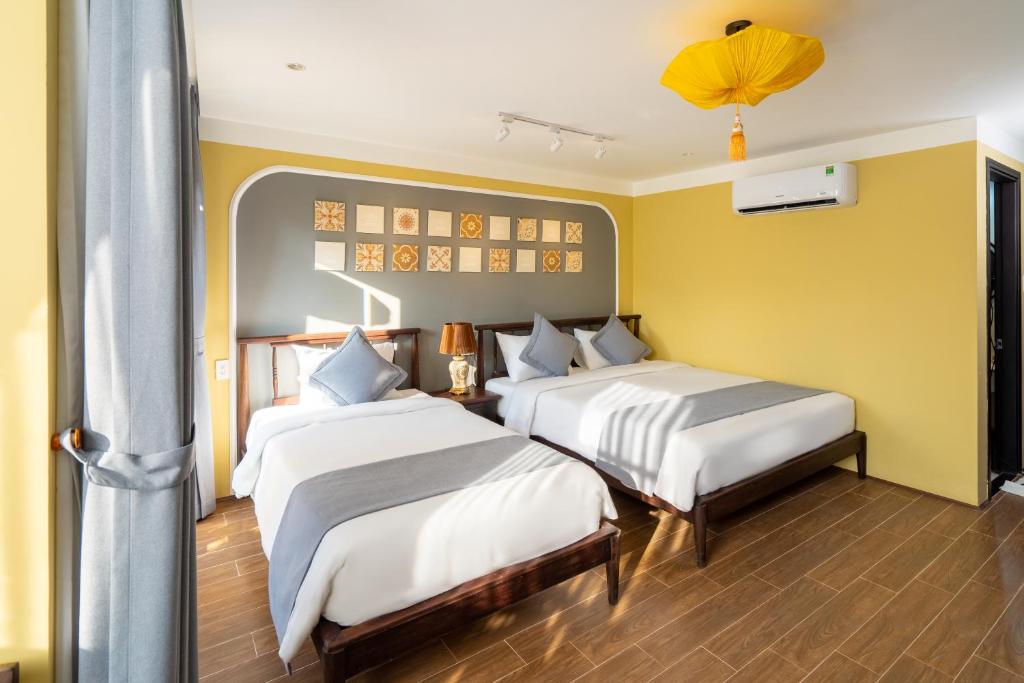 Postel nebo postele na pokoji v ubytování Hoianan Boutique Hotel