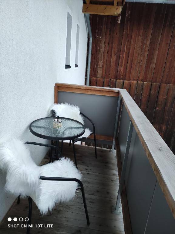 a table and two chairs with white faux fur at groassehof Haus Gstrein in Imsterberg
