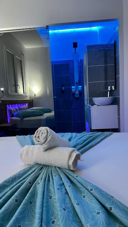 a hotel room with a bed with a towel on it at Domaine de Sainval in Sainte-Rose
