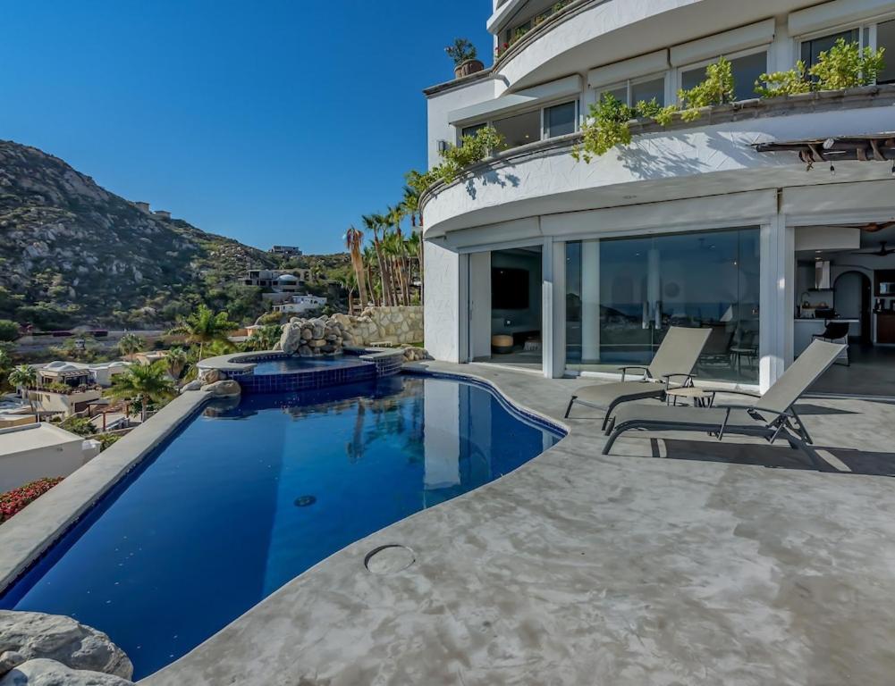 a house with a swimming pool next to a house at The one and only Pedregal Hollywood House in Cabo San Lucas