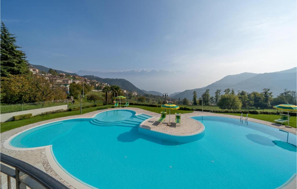 a large swimming pool with mountains in the background at Casa Vacanza Sole in Tremosine Sul Garda