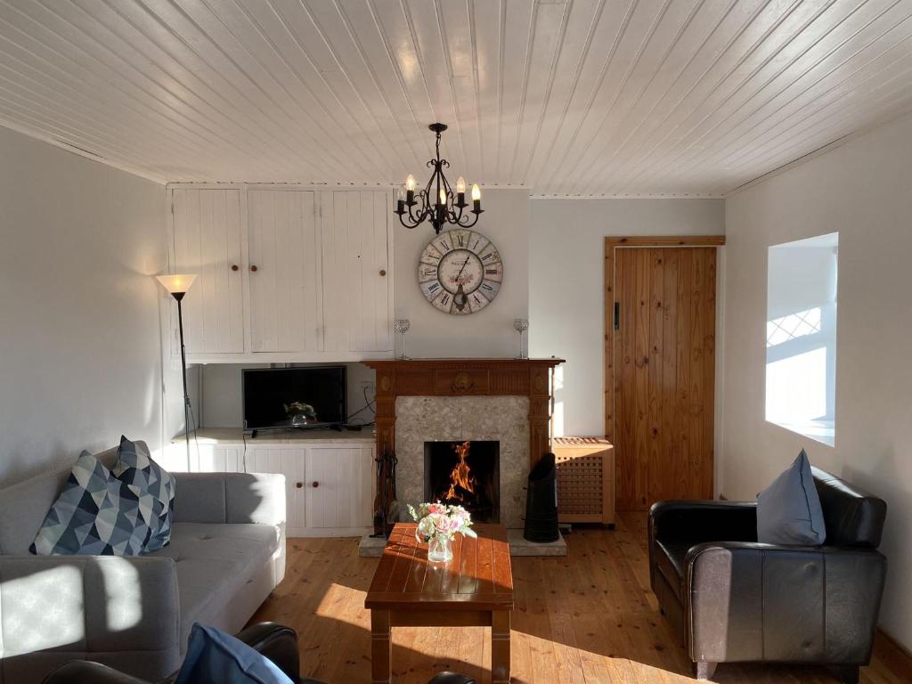 a living room with a couch and a fireplace at Cottage 433 - Ballyconneely in Ballyconneely