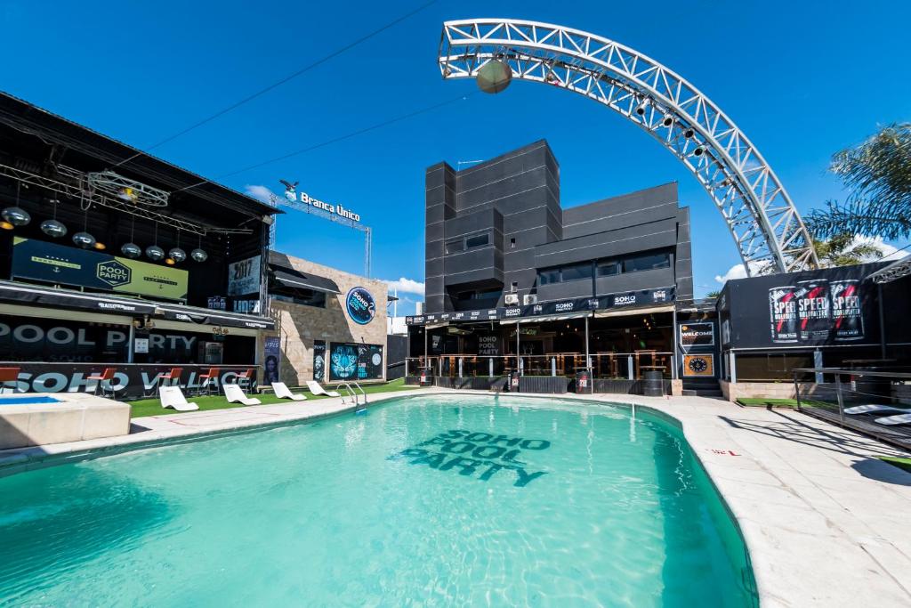 a large swimming pool in front of a stadium at Soho Village in Villa Carlos Paz