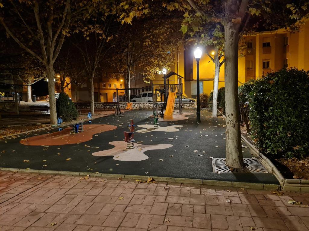 un parque nocturno con un parque infantil con una boca de incendios en LA TERRAZA, en Teruel