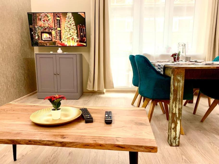 een woonkamer met een houten tafel en een eettafel bij Brand New, Design Apartment JoJo, OldTown, Balcony in Bratislava