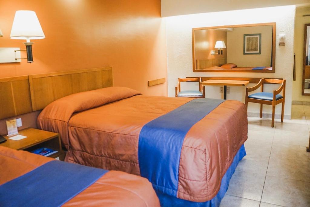 Postel nebo postele na pokoji v ubytování Hotel Jaragua