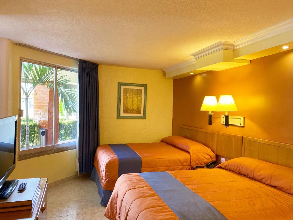 Postel nebo postele na pokoji v ubytování Hotel Jaragua