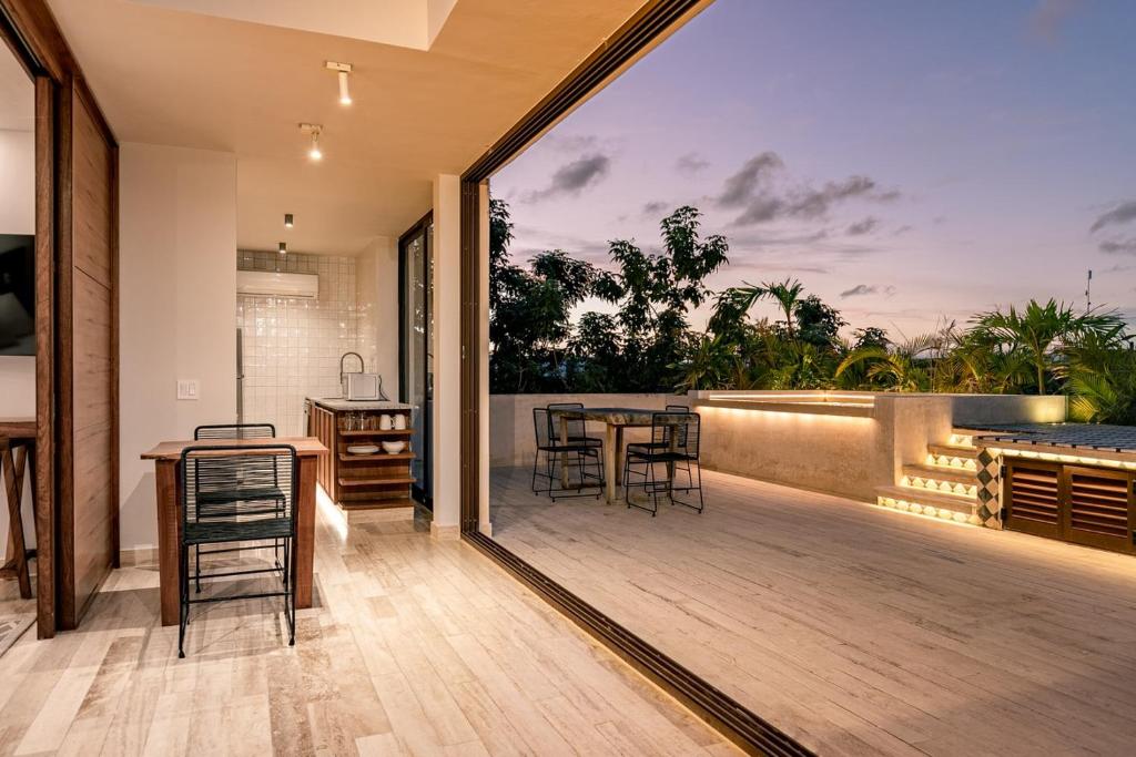 a balcony with a table and chairs on a deck at Casa Libre - Great for couples 1Br with private pool by StayPodio 408 in Tulum