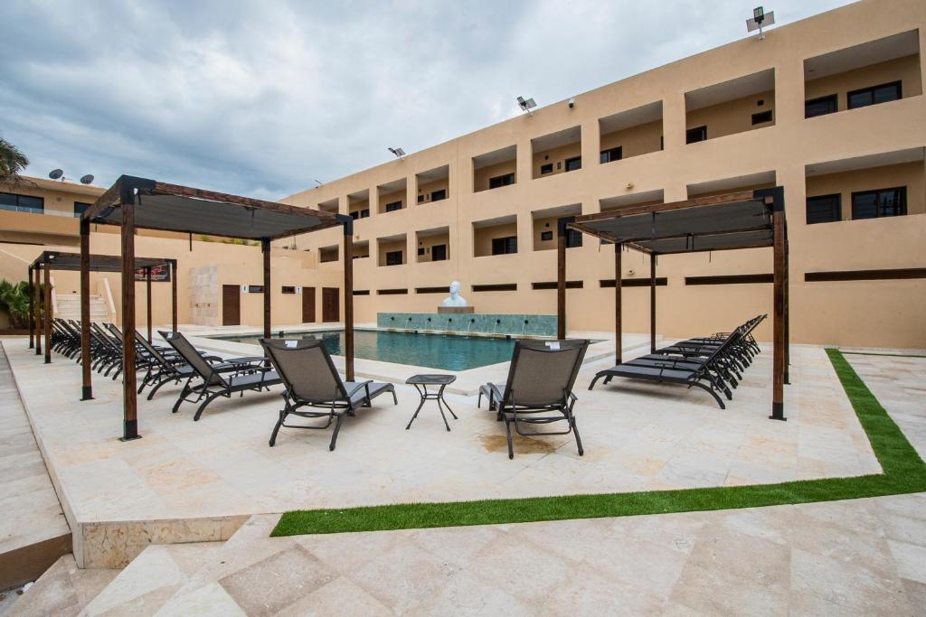 a building with chairs and a swimming pool at Departamentos La Roqueta in La Paz
