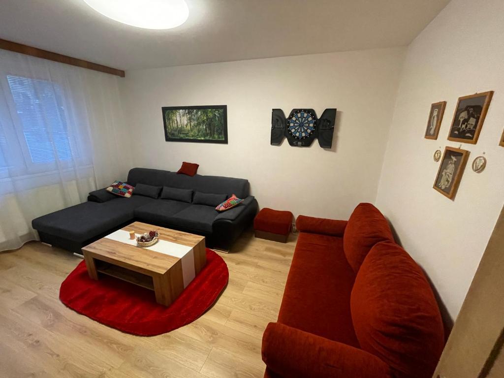 a living room with a couch and a table at Apartmán DoMa - Tatranská Lomnica in Tatranská Lomnica