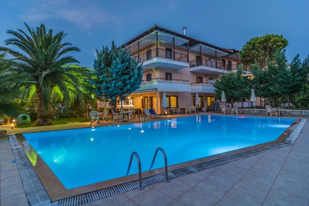 a large swimming pool in front of a building at Hotel Pegasus-Adult Friendly in Limenas