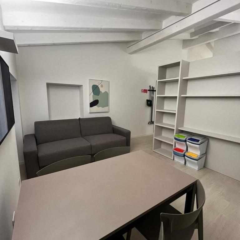 a living room with a couch and a table at Smart Apartments Palazzo Mazzini in Rovereto