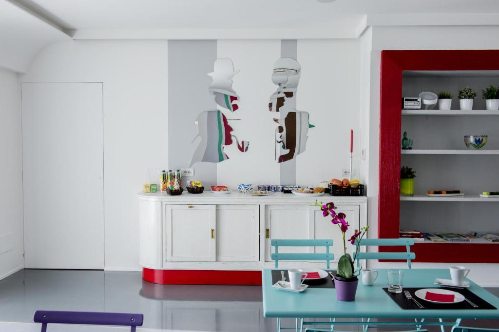 a kitchen with white cabinets and a blue table at Il Castelluccio in Arezzo