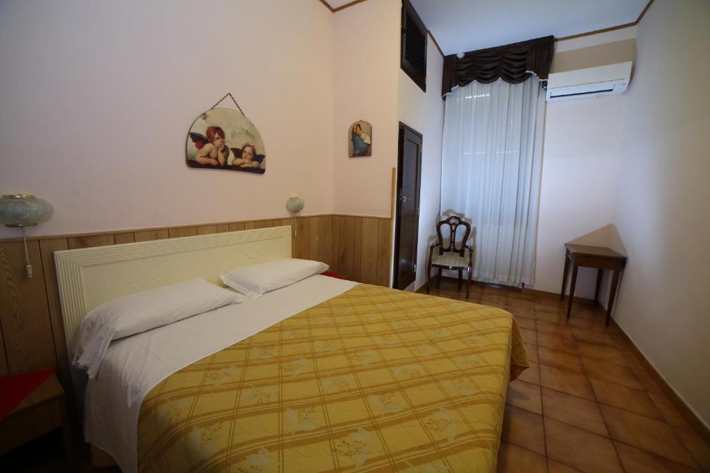 Letto o letti in una camera di Hotel Giugiù