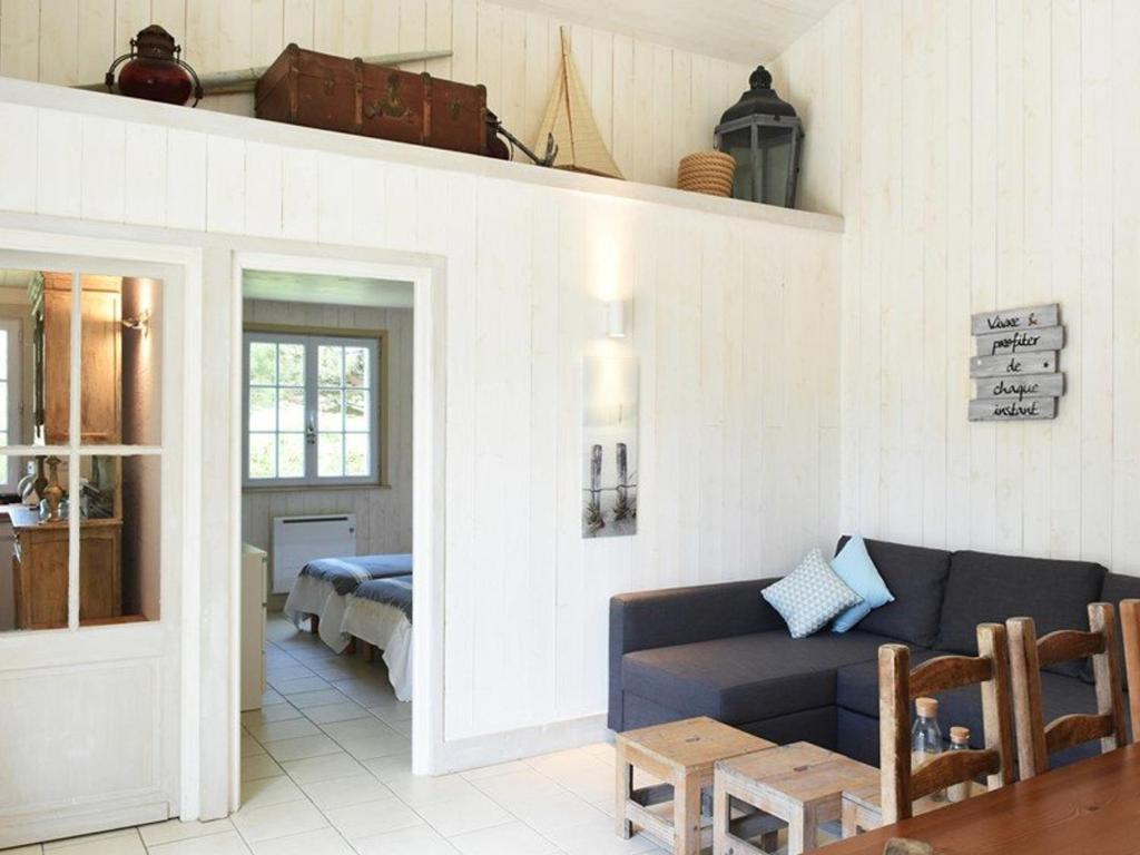 a living room with a couch and a table at Maison Les Portes-en-Ré, 3 pièces, 4 personnes - FR-1-434-73 in Les Portes