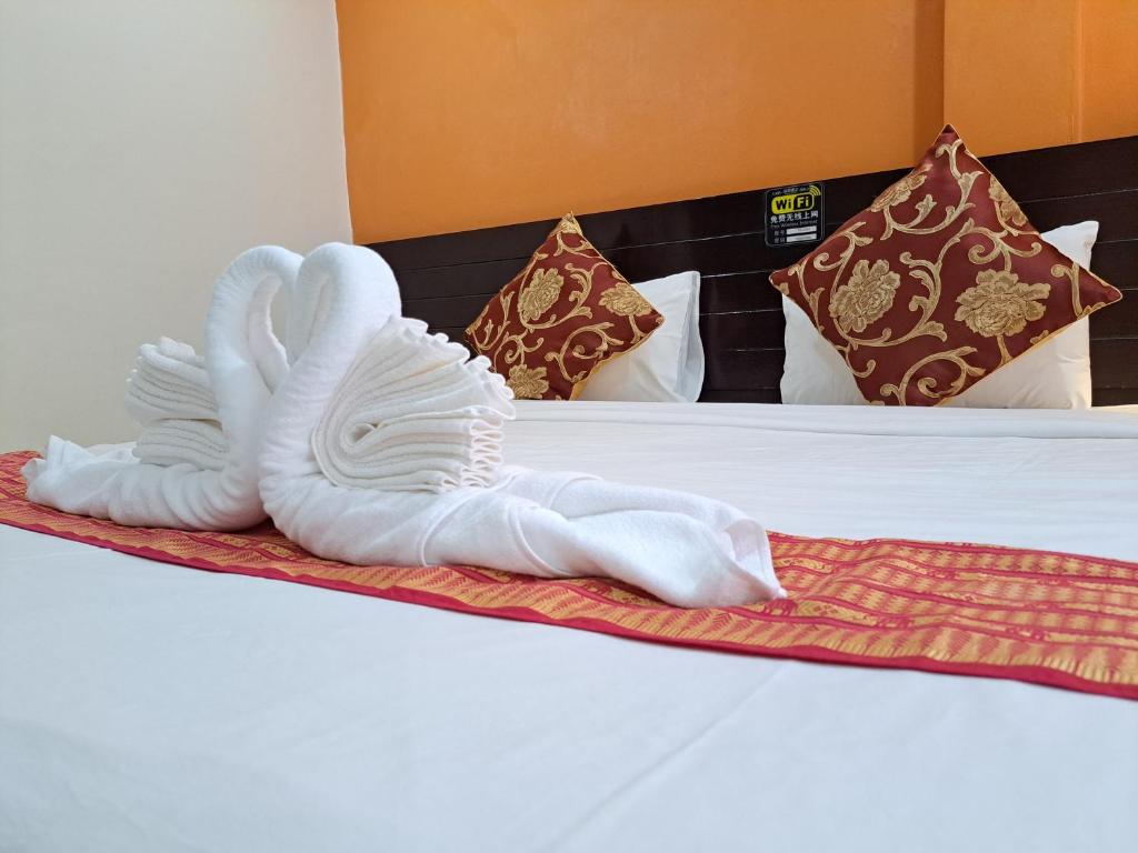 Postel nebo postele na pokoji v ubytování Lily Holiday hotel 百合假日酒店
