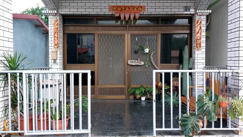 a front door of a house with a gate at Nuan Hostel in Xiaoliuqiu