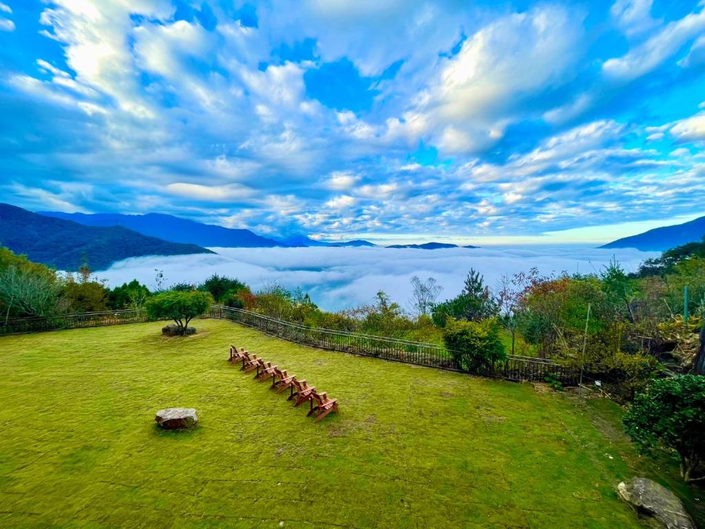 a herd of cows in a field with a view of the mountains at Junyi Landscape Villa in Ren&#39;ai