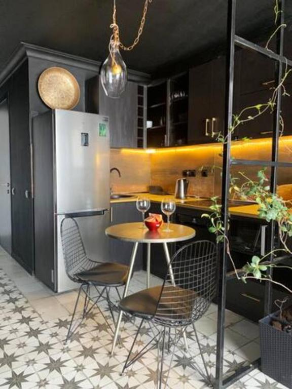 a kitchen with a table and chairs and a refrigerator at New Gudauri Loft 2 Apartment 129 in Gudauri