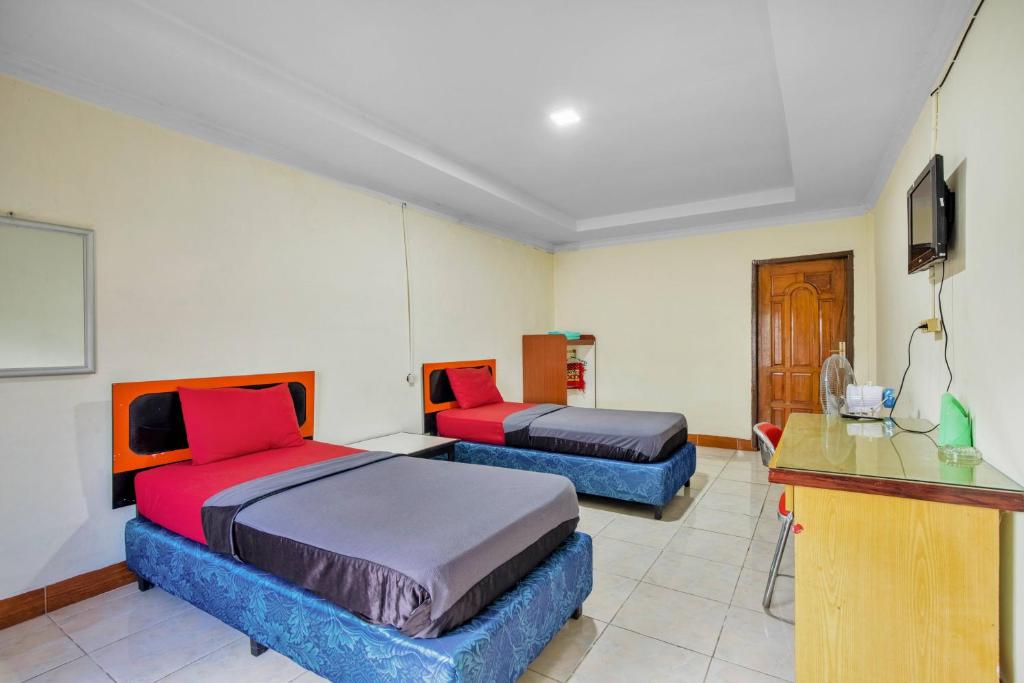 Postel nebo postele na pokoji v ubytování Malibou Hotel Medan