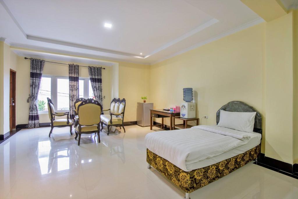 Postel nebo postele na pokoji v ubytování Malibou Hotel Medan