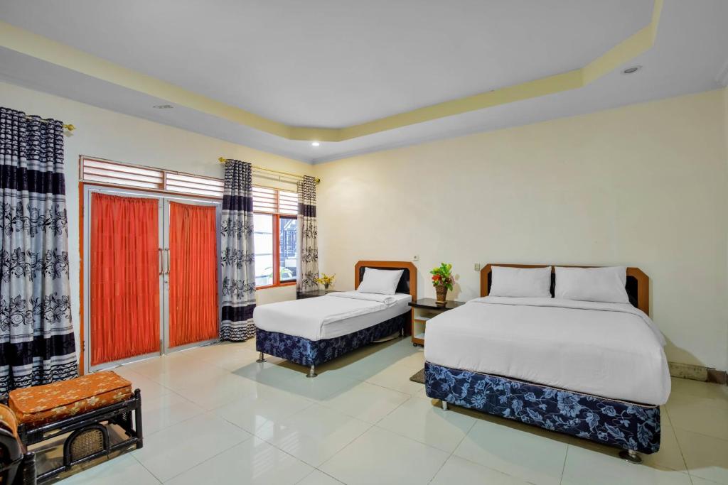 Postel nebo postele na pokoji v ubytování Malibou Hotel Medan