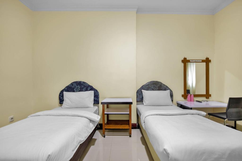 Postel nebo postele na pokoji v ubytování Malibou Hotel Medan