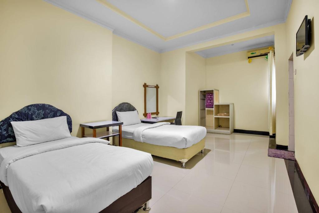 Postel nebo postele na pokoji v ubytování Malibou Hotel Medan