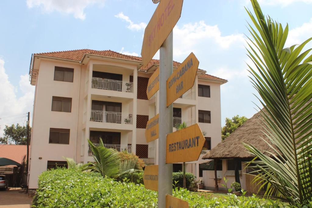 a street sign in front of a building at Sky Hotel International in Kampala