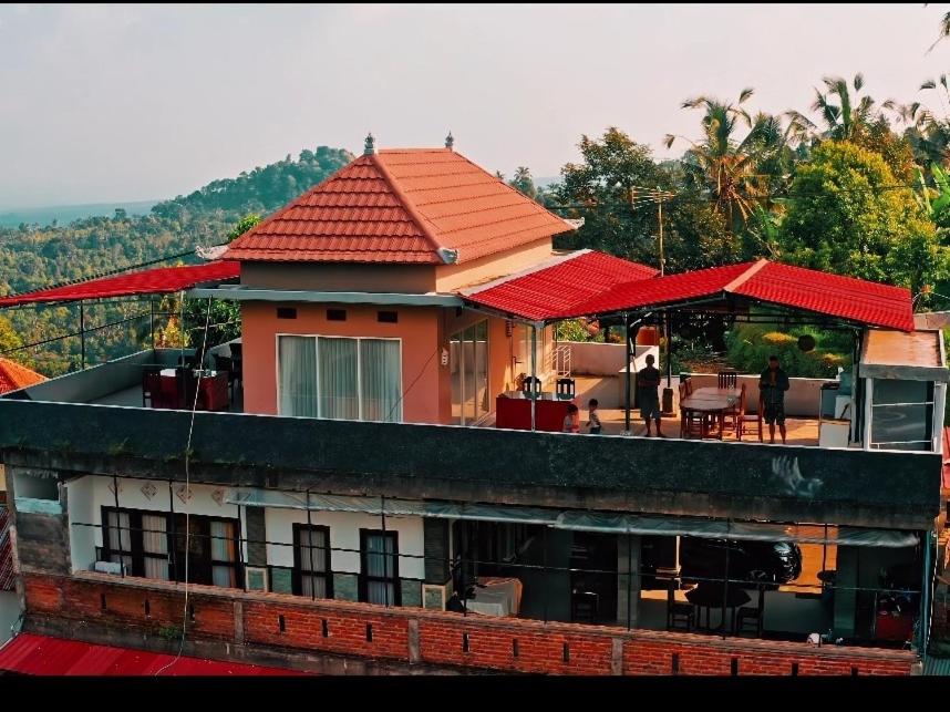 uma casa com um telhado vermelho em cima em Sekumpul BnB em Singaraja