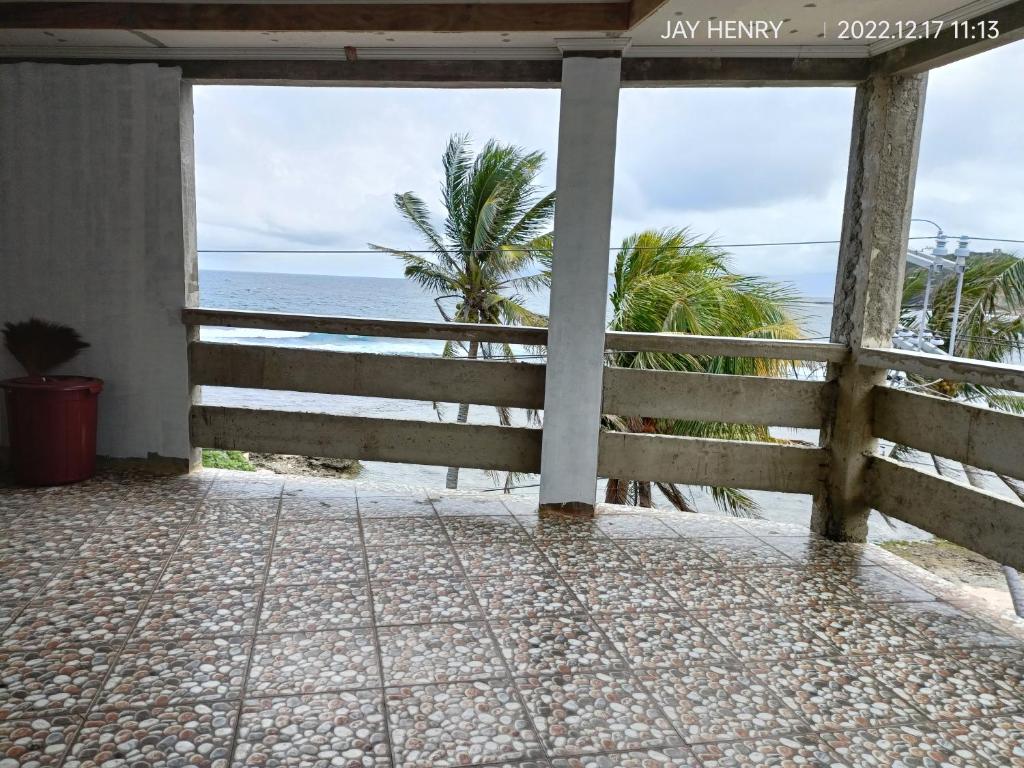 a view of the beach from the porch of a house at Ocean View Room Jay Henry's Transient House in Pagudpud