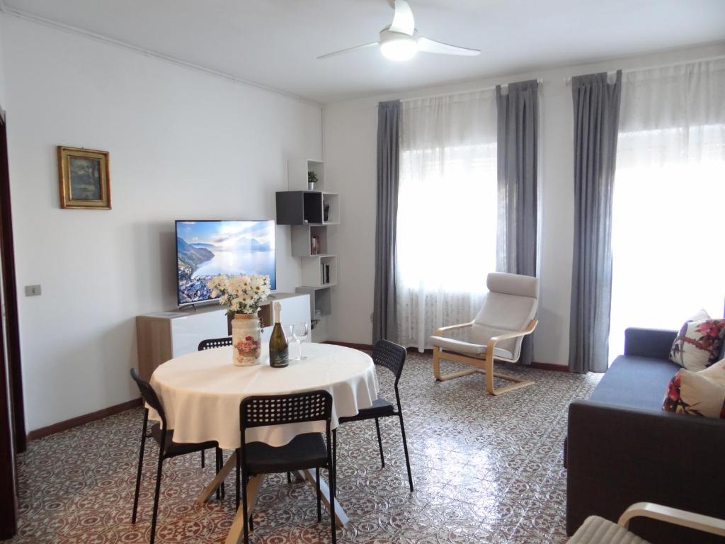 a living room with a table and a couch at Roberta&#39;s House, a few steps from the lake in Bellano