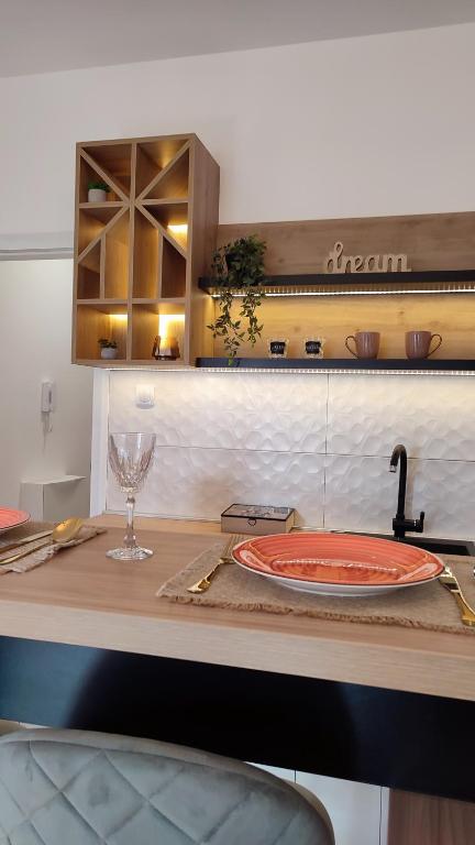 a kitchen with a table with a plate on a counter at Apartman Iskra in Trebinje