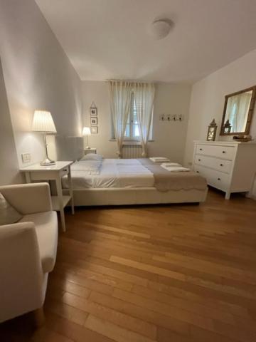 a bedroom with a bed and a desk and a chair at Il Borgo in Trieste