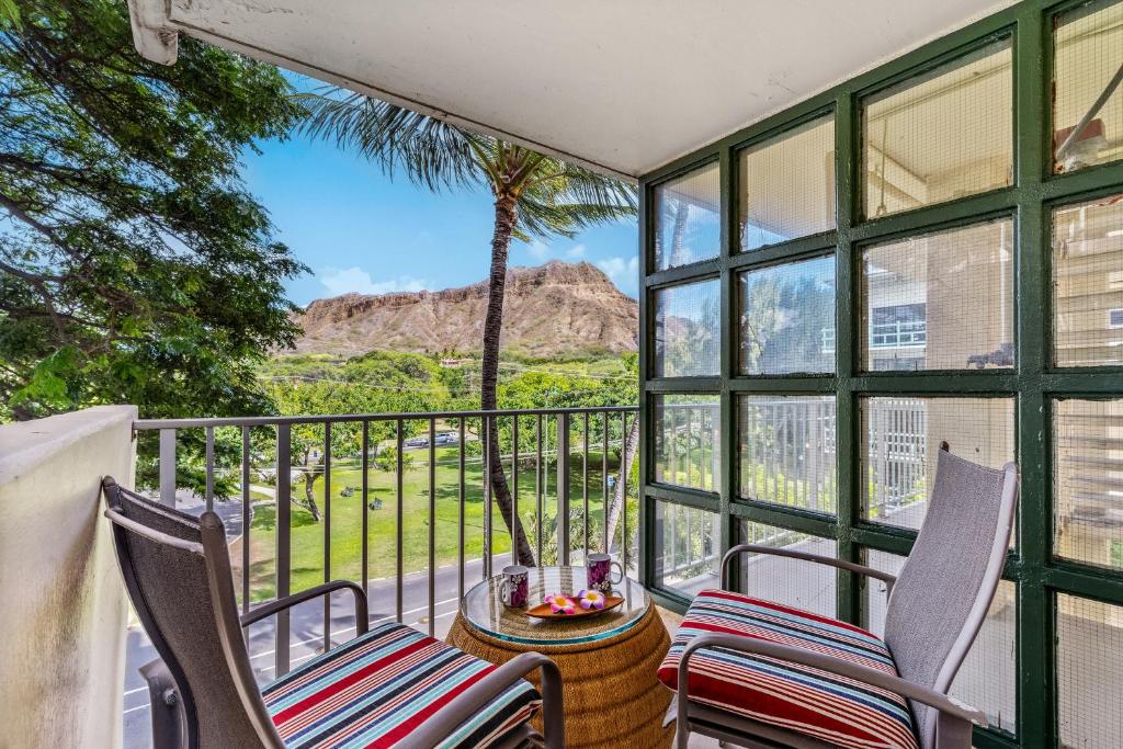 a balcony with chairs and a view of the mountains at @ Marbella Lane -Coastal retreat near Diamond Head in Honolulu