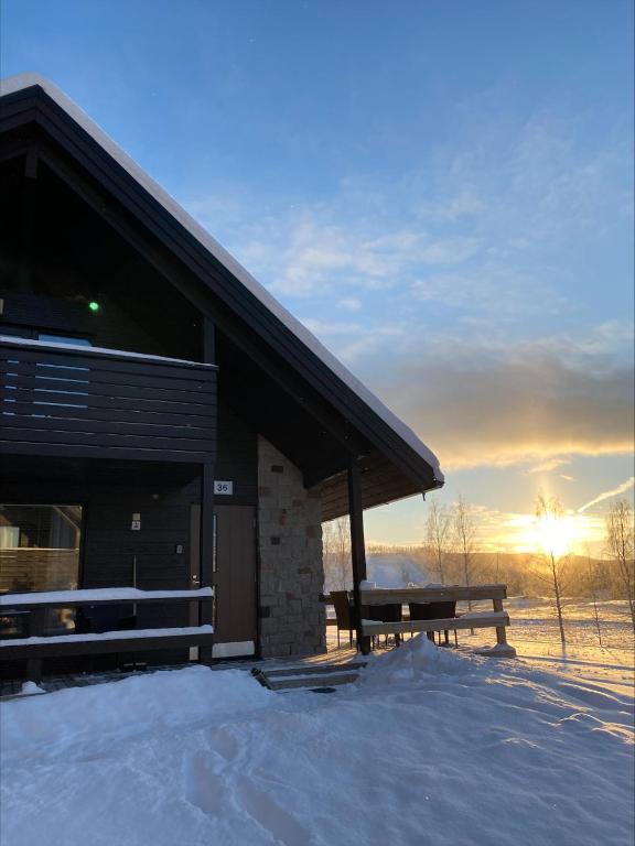 a building with a bench in the snow at Himos Mökki in Jämsä