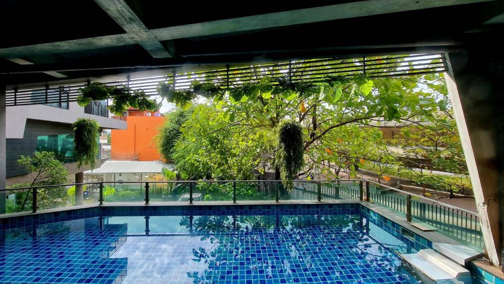 A sheltered outdoor pool overlooking neighboring greenery and buildings.