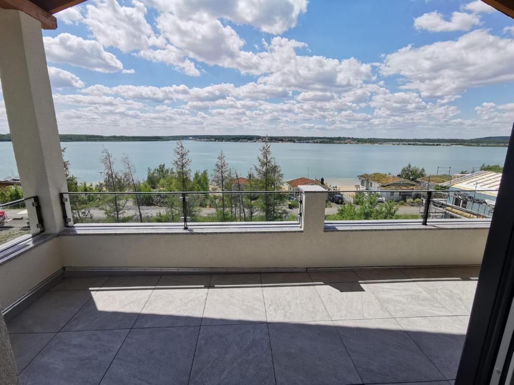 a balcony with a view of a lake at Casa Ida am Hainer See in Neukieritzsch