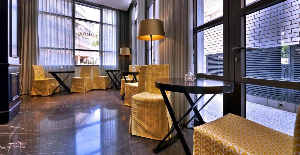 a room with a table and chairs and windows at Hotel Indigo Tel Aviv - Diamond District, an IHG Hotel in Tel Aviv