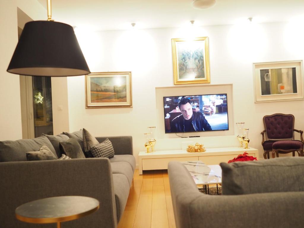 a living room with a couch and a tv at Lilia apartment in Zagreb