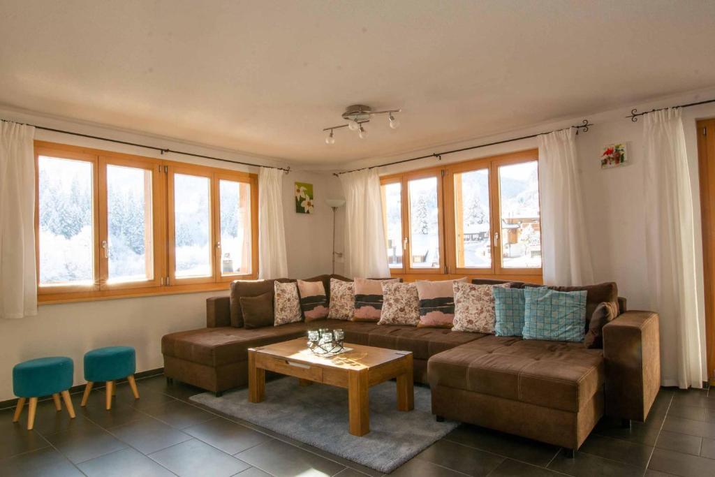 a living room with a couch and a table at Schützenrain 1. Stock in Adelboden