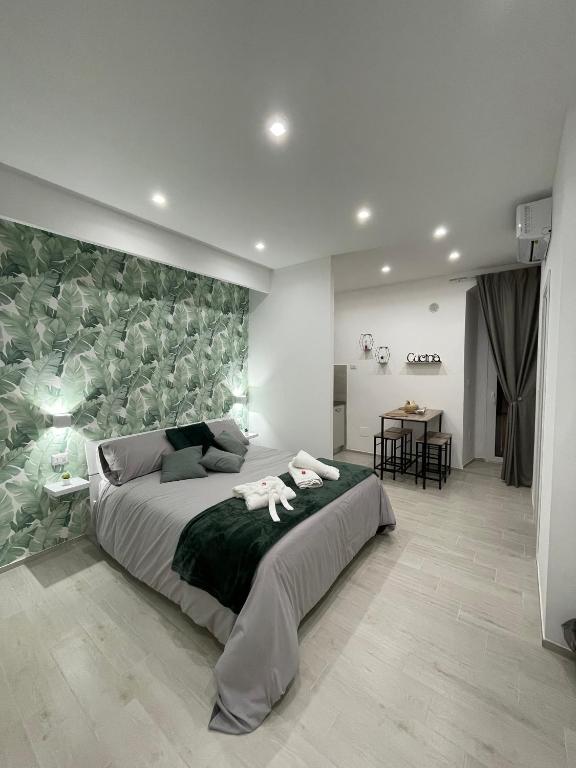 a bedroom with a large bed with a green wall at Casa Vacanza Venere in Barletta