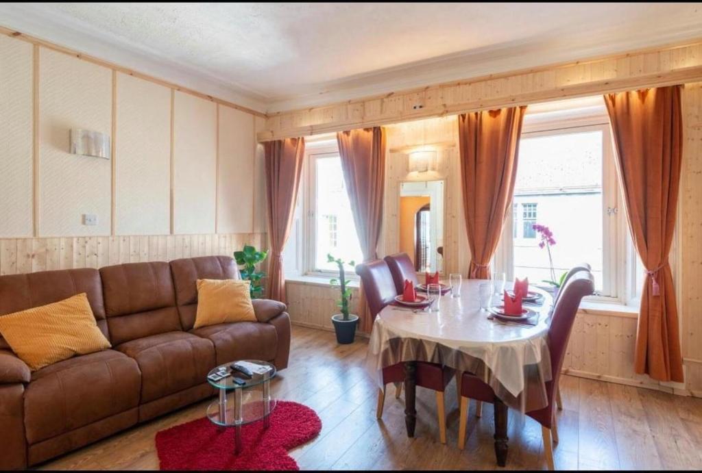 a living room with a couch and a table at Georges57 2-Bed Apartment in Inverness in Inverness