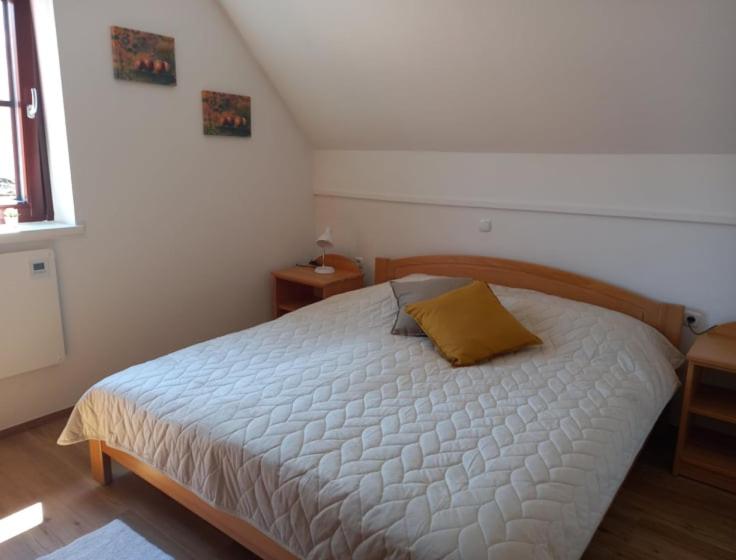 a bedroom with a bed with a yellow pillow on it at DEMI108 in Brežice