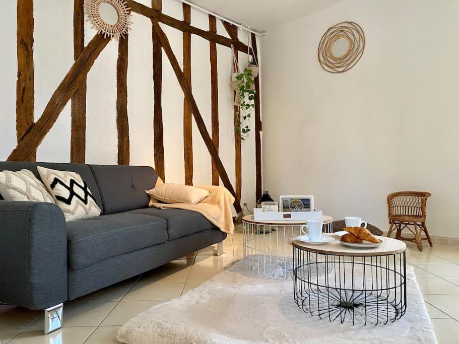 a living room with a blue couch and two tables at Le Cosy Troyen secteur calme 4 personnes parking privé in Troyes