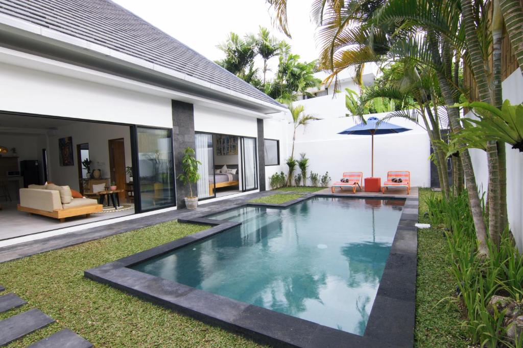 a swimming pool in the backyard of a house at VILLA NIKOLE in Seminyak