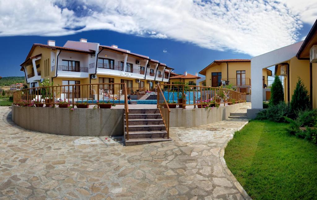 a row of houses with a swimming pool at Montemar Villas in Sunny Beach
