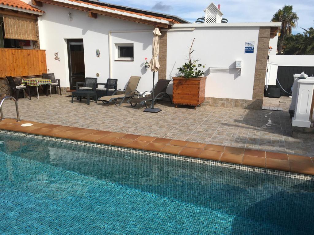 a swimming pool in front of a house at loft patri Caleta de Fuste in Caleta De Fuste